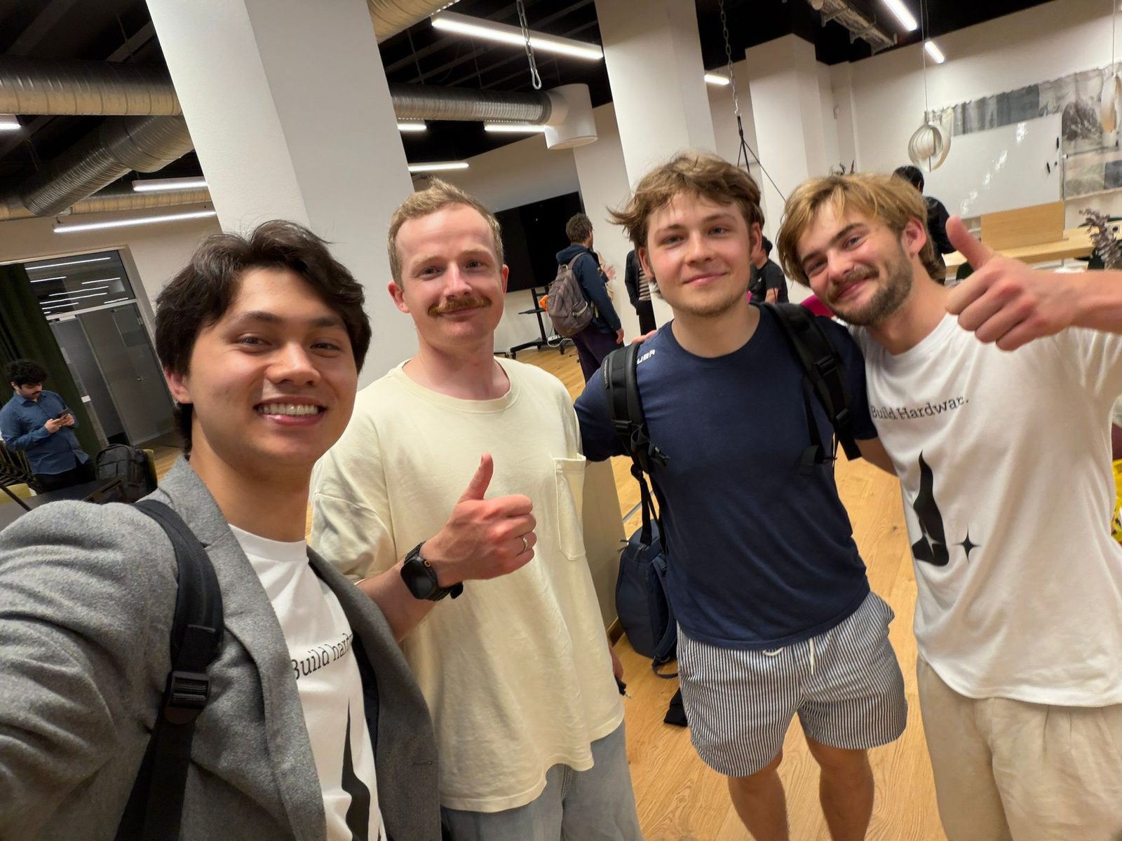 Four builders, thumbs up, selfie in the office