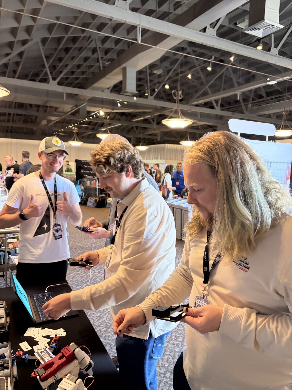 Three visitors examining modules