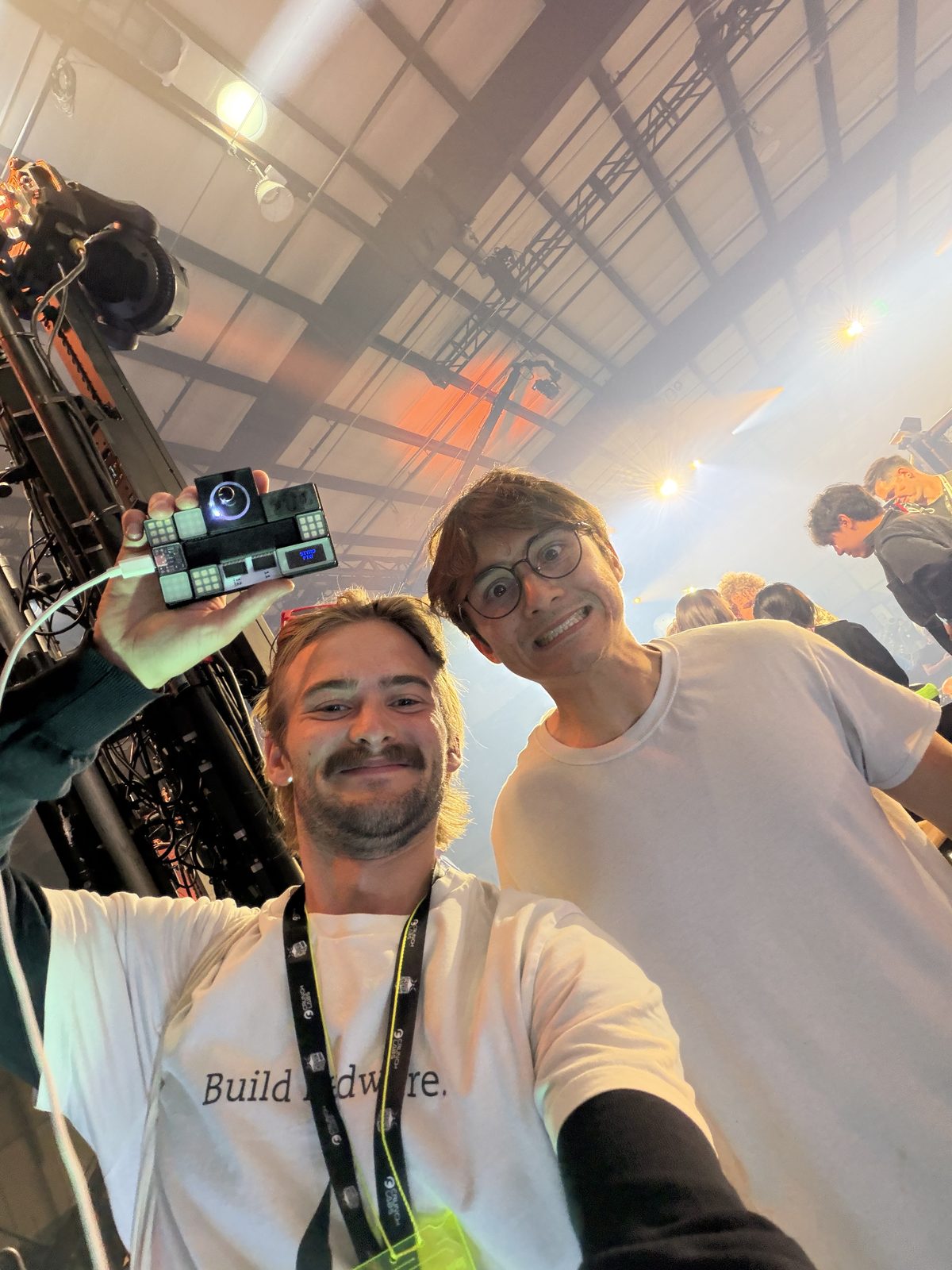 Gustav holding the board with lit modules, Michael Reeves beside him, backstage at the robot fights