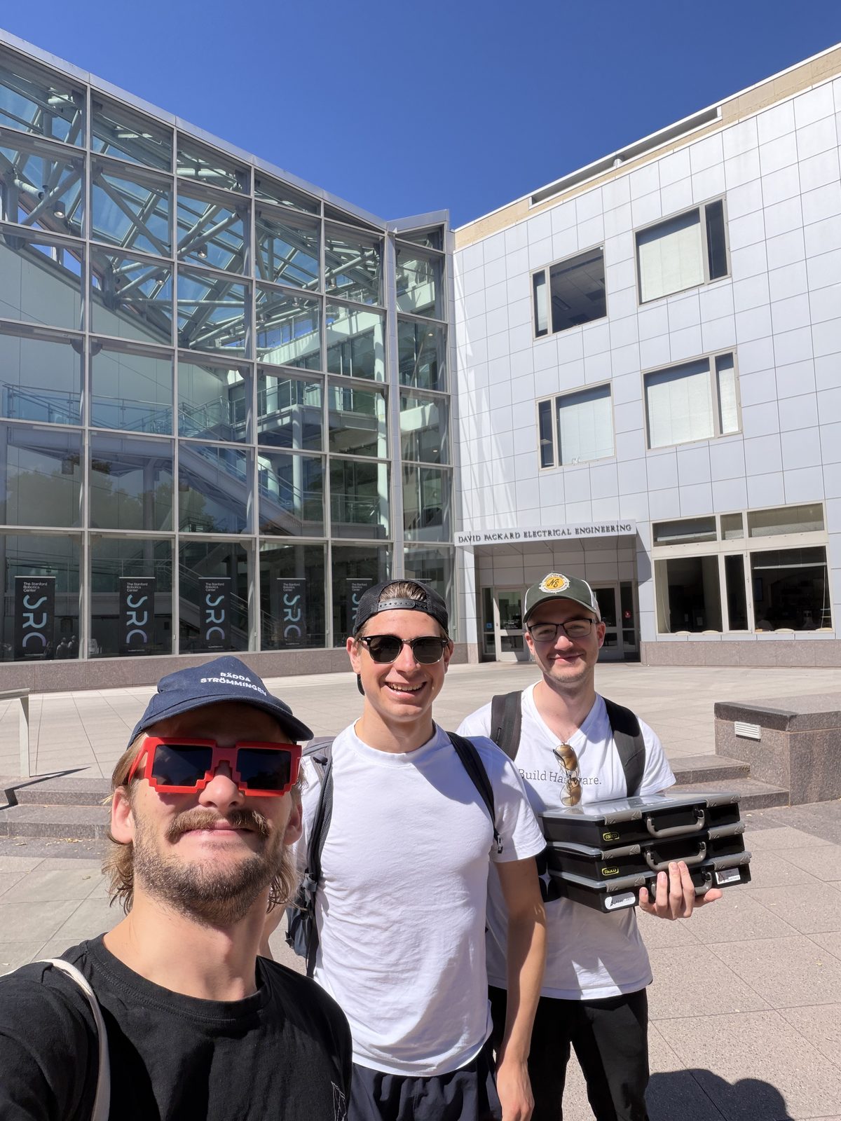 Three of us with kit boxes in front of the Packard building