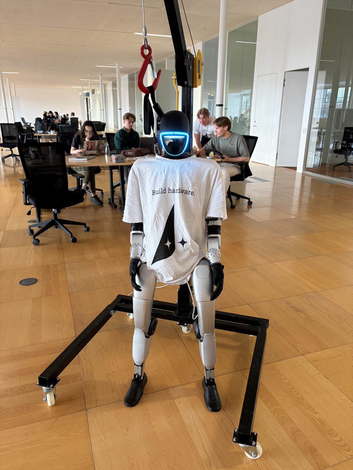 A humanoid robot wearing a Build Hardware shirt