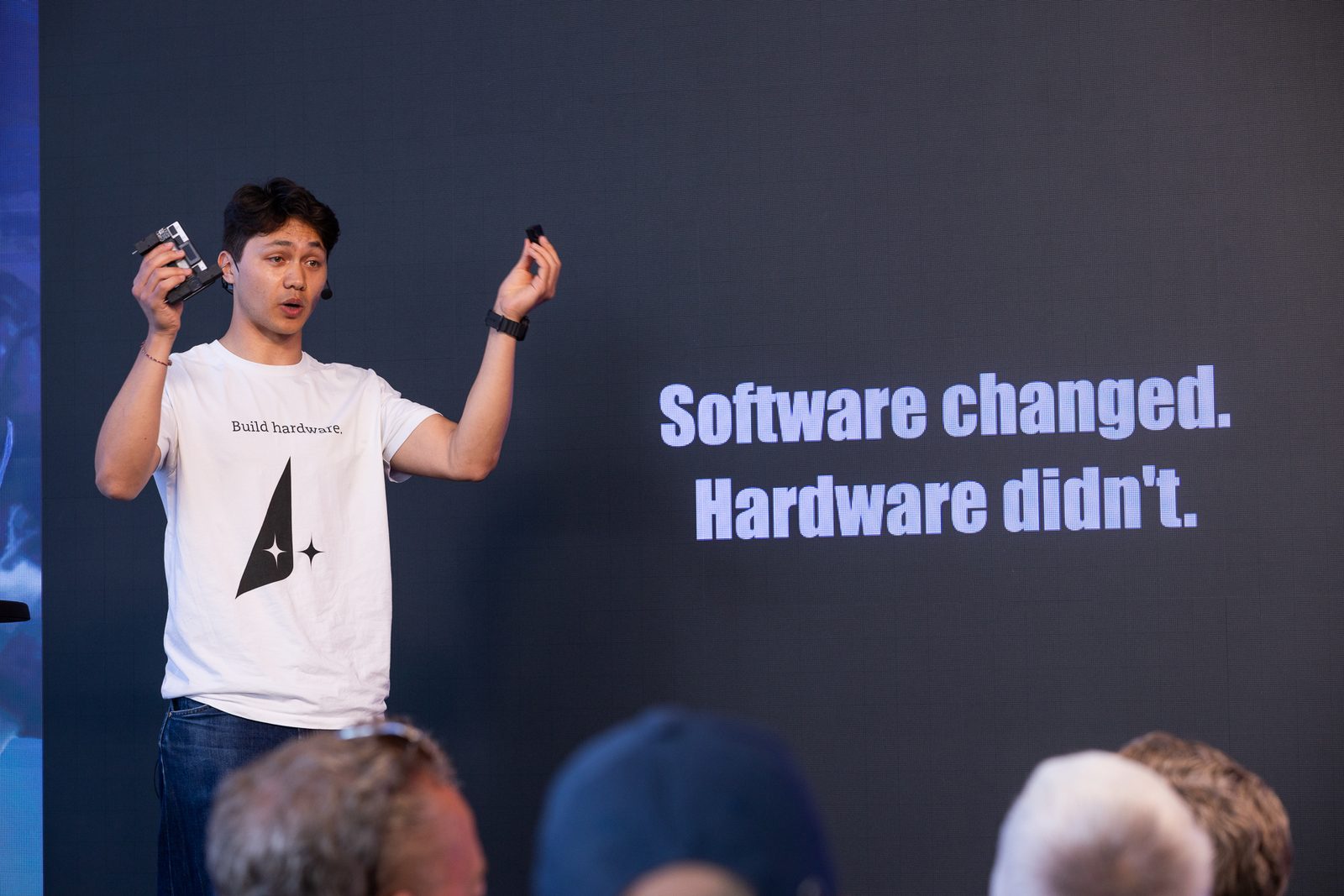 On stage in front of the slide "Software changed. Hardware didn’t."