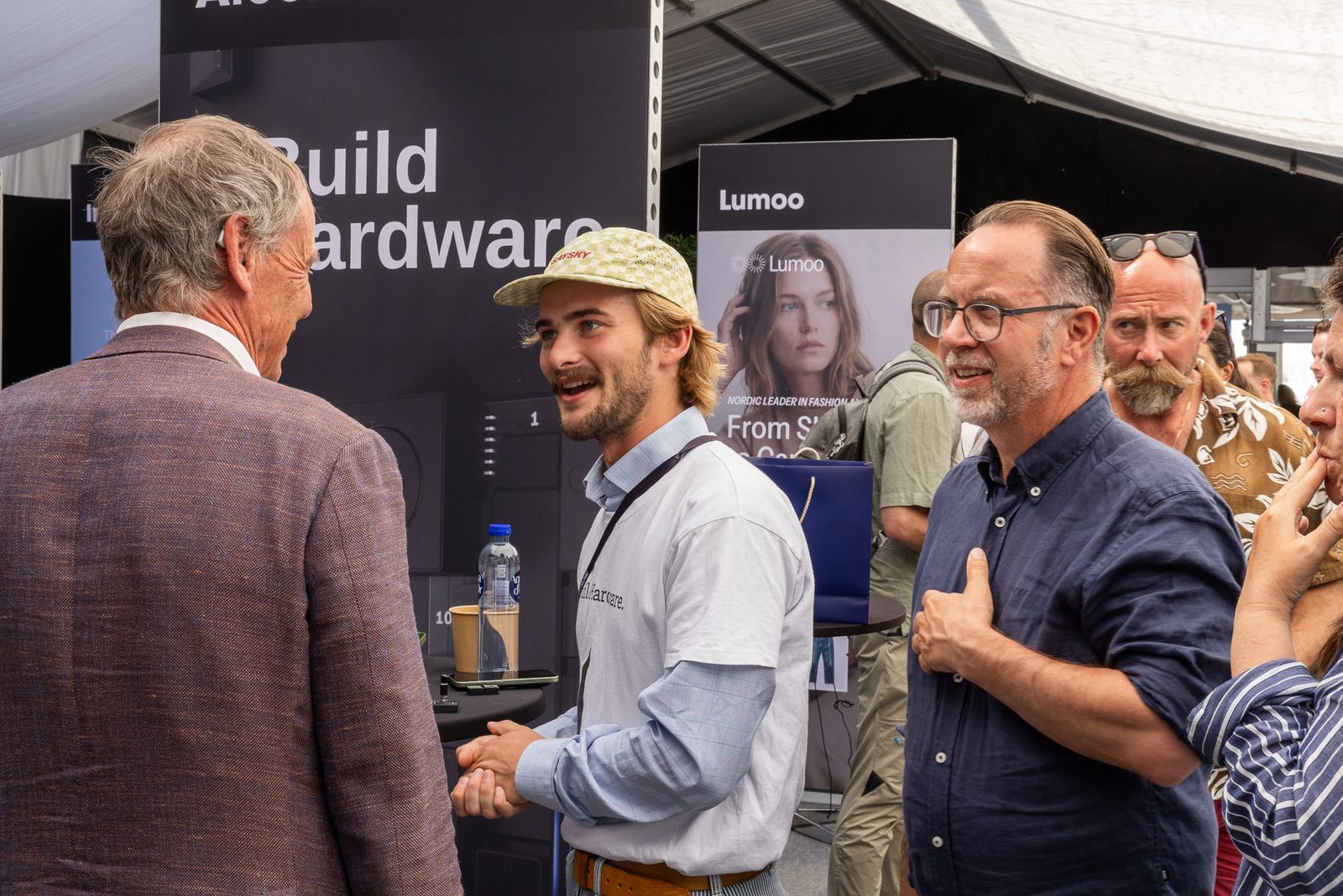 Gustav at the booth with the Build Hardware banner, talking to visitors